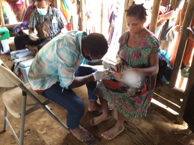 Woman sitting down having her health checked