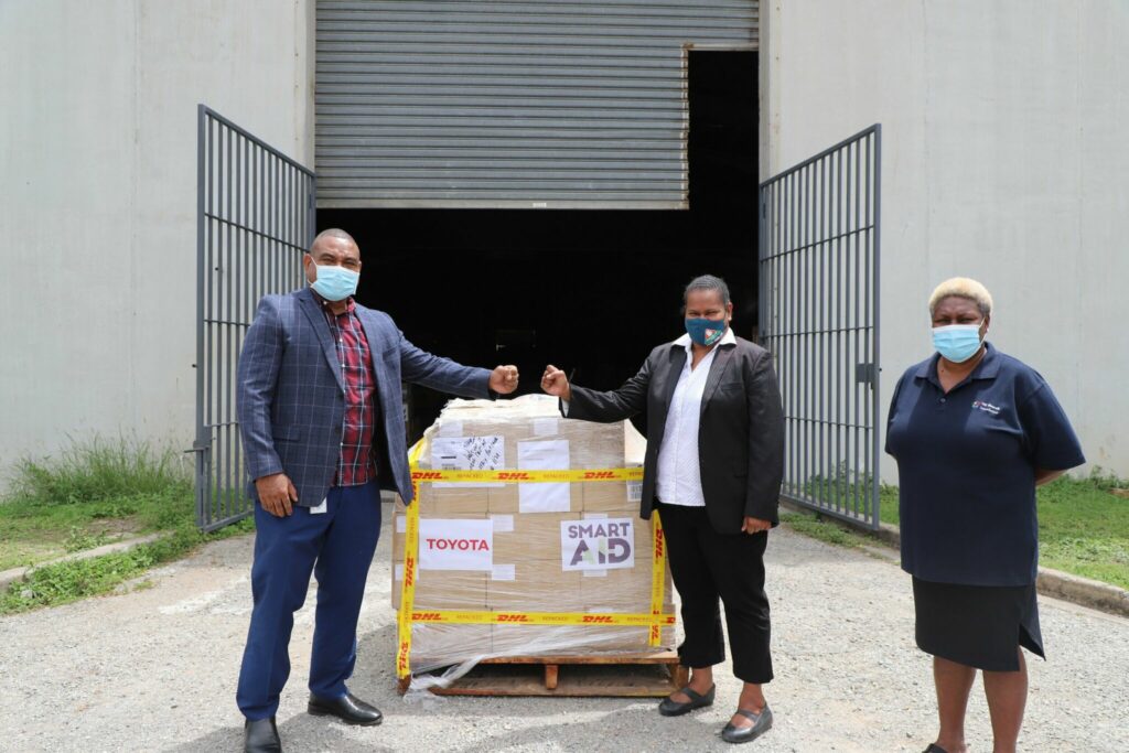 Foundation executive providing facemask package to National Control Centre executive