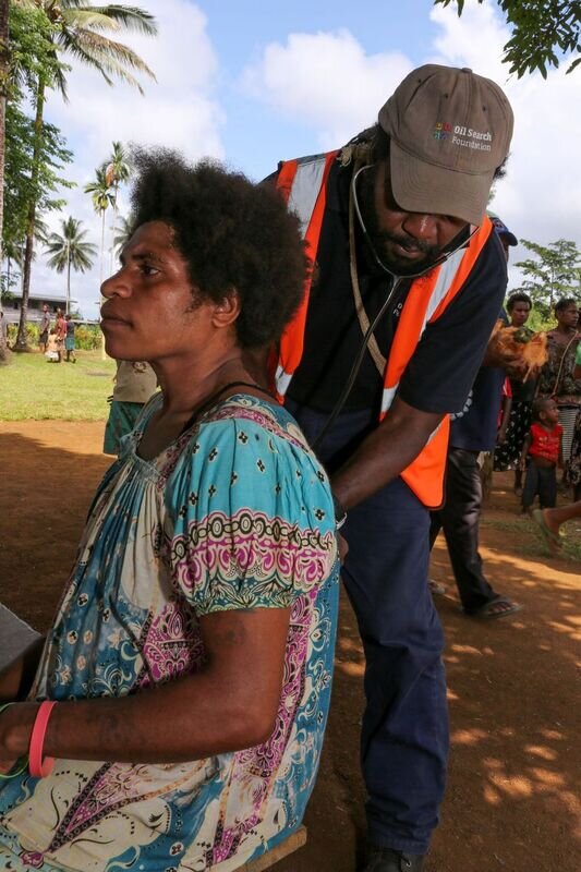 Health worker conducting health check with a local patient